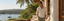 Man in a cream linen hooded shirt and sage trousers on a seaside terrace
